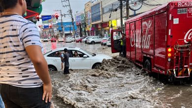 Camión de reparto colocado frente a una fuerte corriente de agua durante un rescate en Acapulco